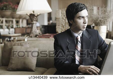 Close-up of a businessman using a laptop View Large Photo Image Stock Photo - Close-up of a businessman using a laptop. Fotosearch