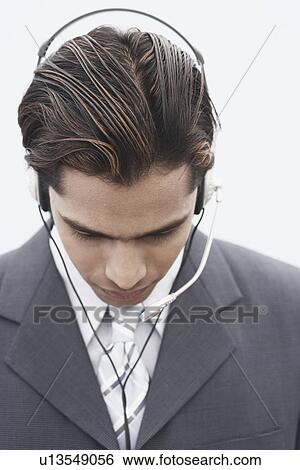 Stock Photograph - Close-up of a businessman wearing a headset. Fotosearch