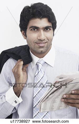 Stock Photo - Portrait of a businessman holding a newspaper. Fotosearch