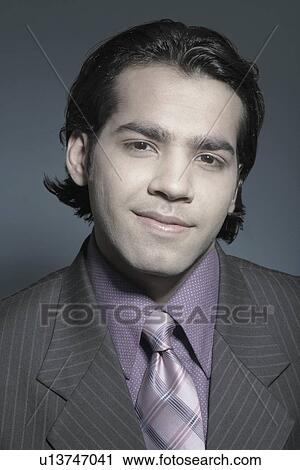 Stock Image - Portrait of a businessman smiling. Fotosearch