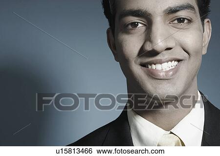 Stock Photograph - Portrait of a businessman smiling. Fotosearch