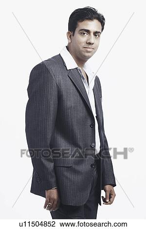 Stock Image - Side profile of a businessman standing. Fotosearch