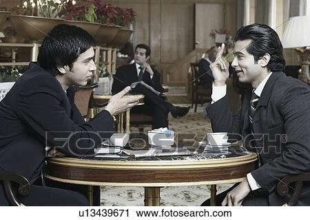 Side profile of two businessmen talking View Large Photo Image Stock Image - Side profile of two businessmen talking. Fotosearch
