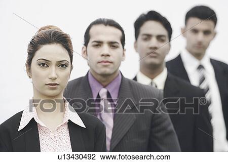 Stock Image - Business executives standing in a row. Fotosearch