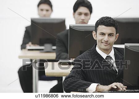 Stock Photograph - Businessman working on a computer. Fotosearch