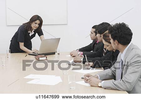 Stock Photo - Businesswoman giving a presentation. Fotosearch