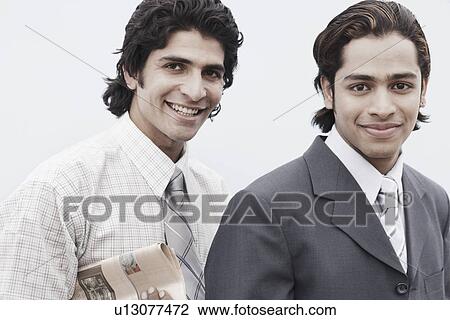 Stock Image - Close-up of two businessmen smiling. Fotosearch