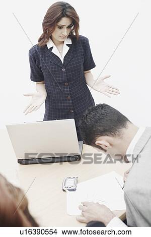 Picture - High angle view of a businesswoman looking at a businessman. Fotosearch