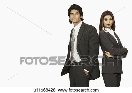 Portrait of a businessman and a businesswoman standing back to back View Large Photo Image Stock Photo - Portrait of a businessman and a businesswoman standing back to back. Fotosearch