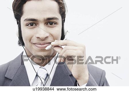 Portrait of a businessman wearing a headset View Large Photo Image Picture - Portrait of a businessman wearing a headset. Fotosearch