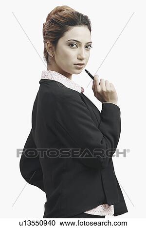 Portrait of a businesswoman holding a pen View Large Photo Image Stock Image - Portrait of a businesswoman holding a pen. Fotosearch