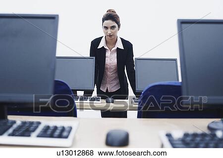 Stock Photo - Portrait of a businesswoman leaning against the table. Fotosearch