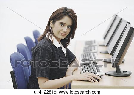 Stock Photography - Portrait of a businesswoman sitting in front of a computer. Fotosearch