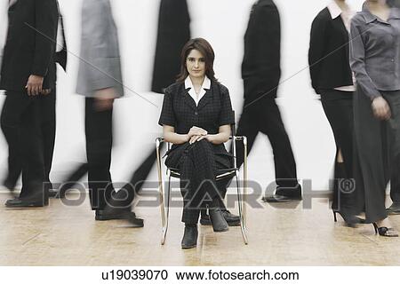 Stock Image - Portrait of a businesswoman sitting on a chair. Fotosearch