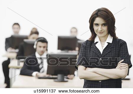 Stock Photo - Portrait of a businesswoman standing in an office. Fotosearch