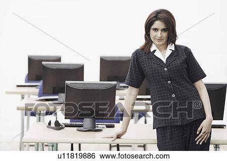 Stock Photograph - Portrait of a businesswoman standing in an office. Fotosearch