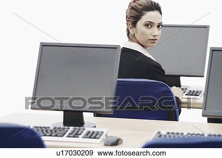 Stock Photo - Portrait of a businesswoman working on a computer. Fotosearch