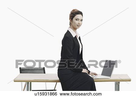 Stock Photograph - Portrait of a businesswoman working on a laptop. Fotosearch