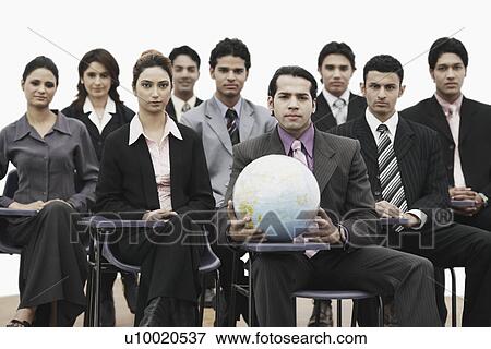 Portrait of a group of business executives sitting in a meeting View Large Photo Image Stock Photo - Portrait of a group of business executives sitting in a meeting. Fotosearch