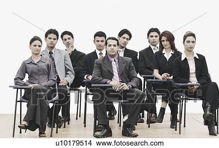 Portrait of business executives sitting on chairs View Large Photo Image Picture - Portrait of business executives sitting on chairs. Fotosearch