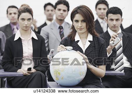 Stock Photo - Portrait of business executives sitting in a meeting. Fotosearch