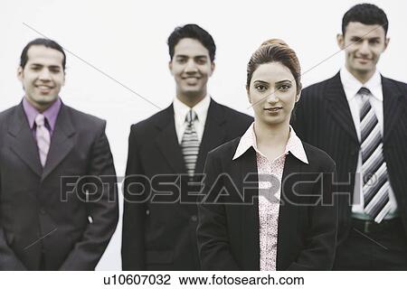 Stock Image - Portrait of business executives smiling. Fotosearch