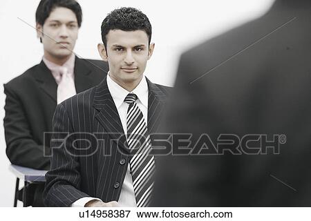 Stock Photo - Two businessmen in an office. Fotosearch