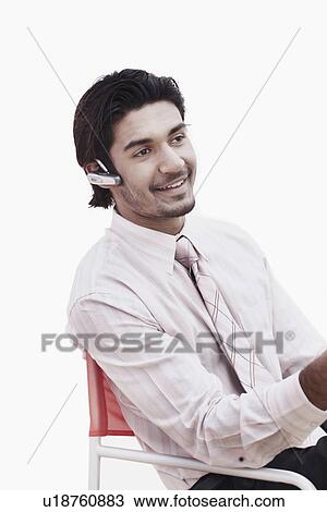 Close-up of a businessman wearing a hands free device View Large Photo Image Stock Image - Close-up of a businessman wearing a hands free device. Fotosearch