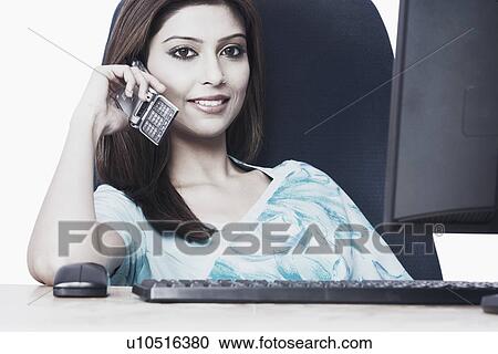 Stock Image - Close-up of a businesswoman talking on a mobile phone. Fotosearch