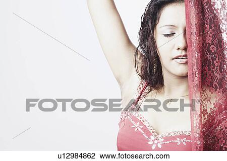 Close-up of a young woman covering her face with a veil View Large Photo Image Stock Image - Close-up of a young woman covering her face with a veil. Fotosearch