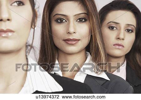 Stock Image - Close-up of three businesswomen. Fotosearch