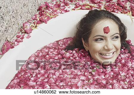 High angle view of a young woman lying in a bathtub covered with flower petals View Large Photo Image Stock Image - High angle view of a young woman lying in a bathtub covered with flower petals. Fotosearch