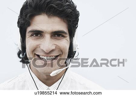 Picture - Portrait of a businessman wearing a headset. Fotosearch