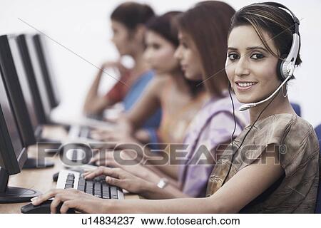 Portrait of a businesswoman sitting in front of a computer View Large Photo Image Stock Photo - Portrait of a businesswoman sitting in front of a computer. Fotosearch