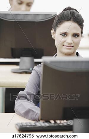 Stock Photography - Portrait of a businesswoman sitting in front of a computer. Fotosearch