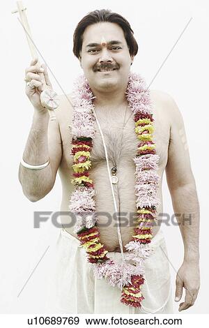 Portrait of a priest wearing a garland View Large Photo Image Stock Photo - Portrait of a priest wearing a garland. Fotosearch
