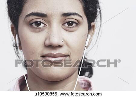 Portrait of a young woman listening to music View Large Photo Image Stock Photography - Portrait of a young woman listening to music. Fotosearch