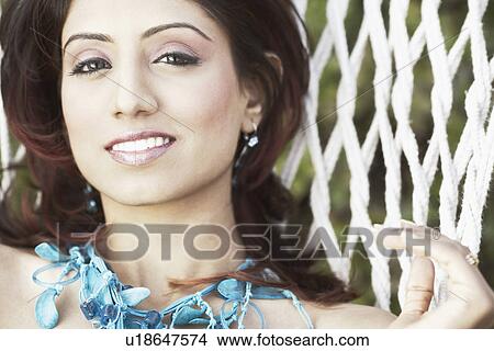 Portrait of a young woman lying in a hammock View Large Photo Image Picture - Portrait of a young woman lying in a hammock. Fotosearch