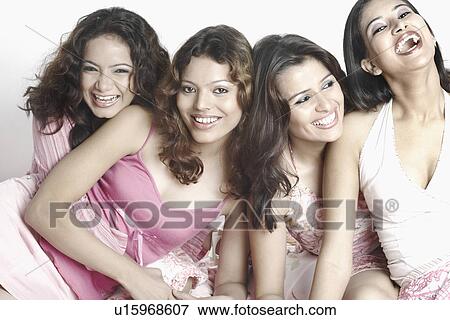Stock Photo - Close-up of four young women smiling. Fotosearch