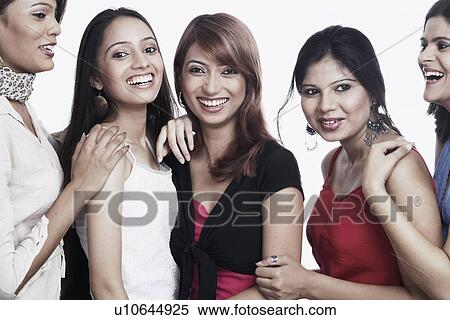 Stock Photography - Four young women and a teenage girl smiling. Fotosearch