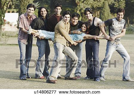 Stock Photo - Portrait of a group of young men carrying a young woman. Fotosearch