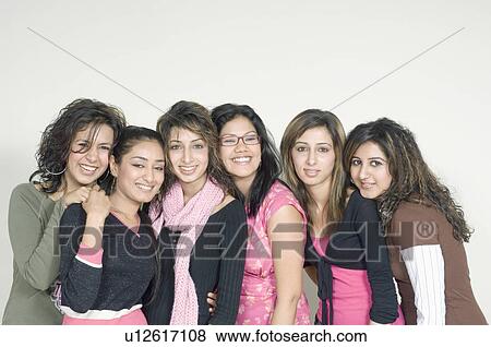 Stock Photo - Portrait of a group of young women in front of a laptop. Fotosearch