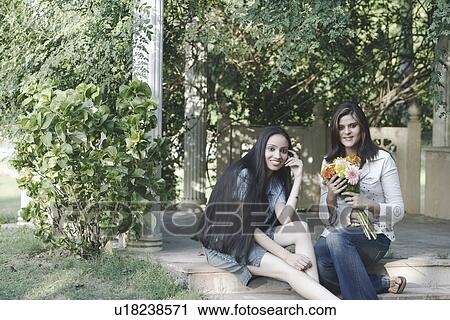 Portrait of a teenage girl a young woman sitting on a step View Large Photo Image Stock Image - Portrait of a teenage girl a young woman sitting on a step. Fotosearch