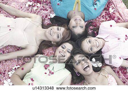 Portrait of a teenage girl and four young women lying on their back View Large Photo Image Stock Photo - Portrait of a teenage girl and four young women lying on their back. Fotosearch