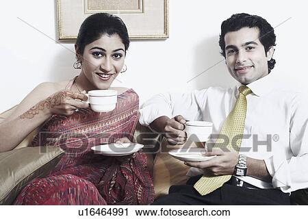 Stock Image - Portrait of a young couple drinking tea. Fotosearch