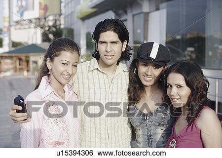 Portrait of a young man and three young women smiling View Large Photo Image Stock Photograph - Portrait of a young man and three young women smiling. Fotosearch
