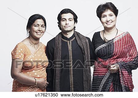 Stock Image - Portrait of a young man and two mature women smiling. Fotosearch