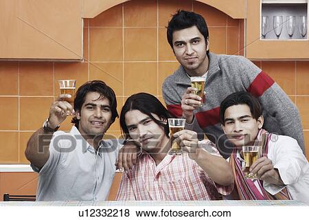 Portrait of four young men holding beer glasses View Large Photo Image Stock Photo - Portrait of four young men holding beer glasses. Fotosearch