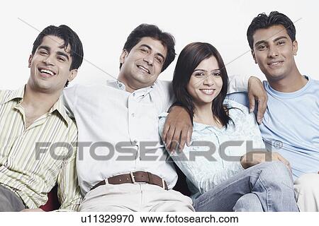 Stock Image - Portrait of three young men and a young woman smiling. Fotosearch