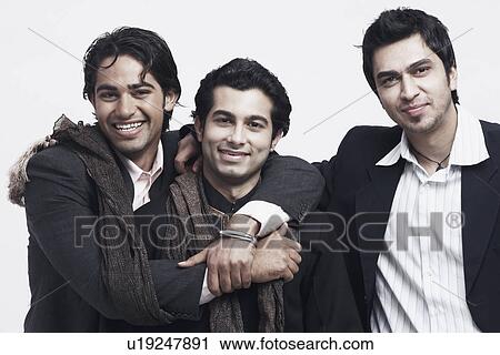 Stock Image - Portrait of three young men smiling. Fotosearch